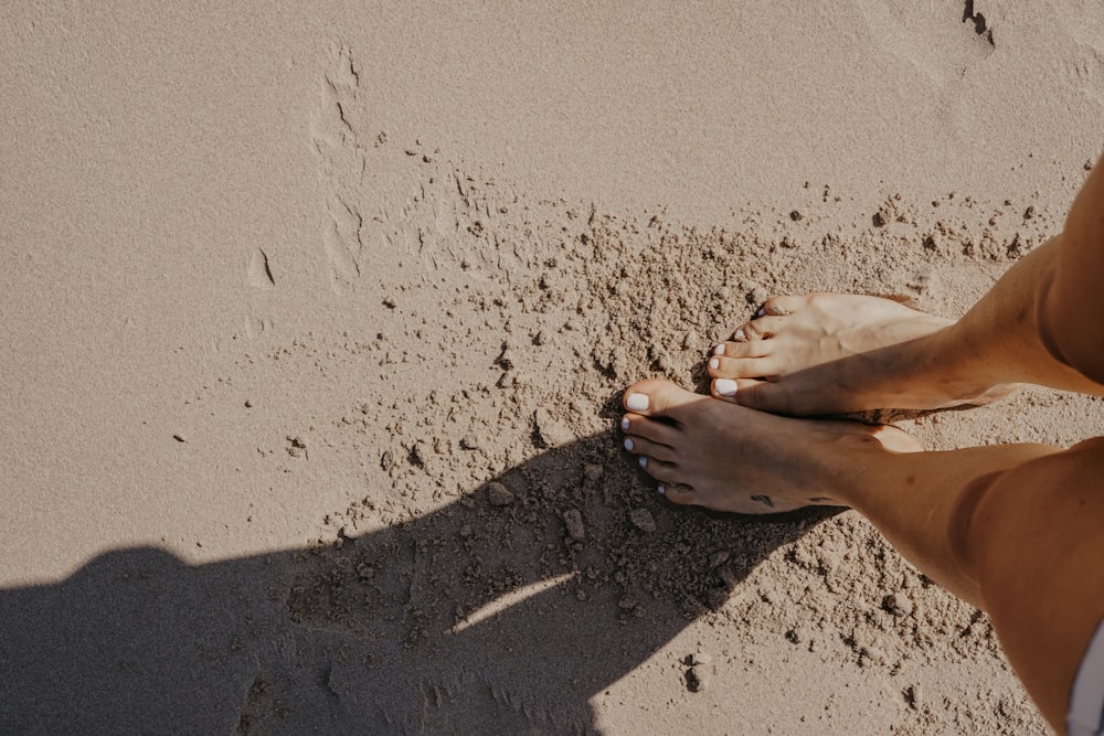 person stepping on sand