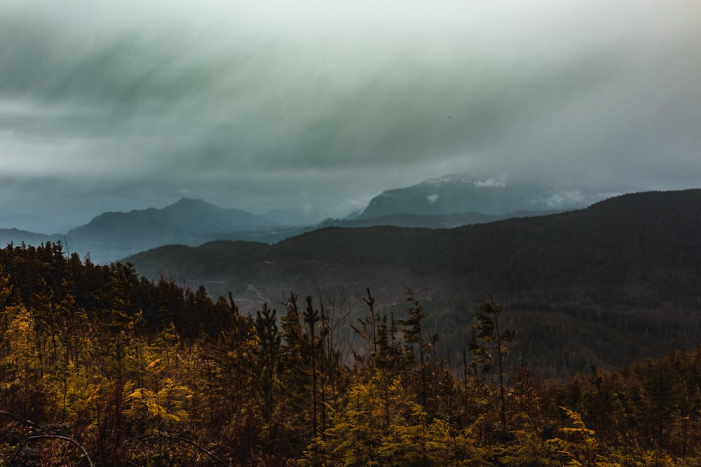 a view of a mountain range with clouds in the sky