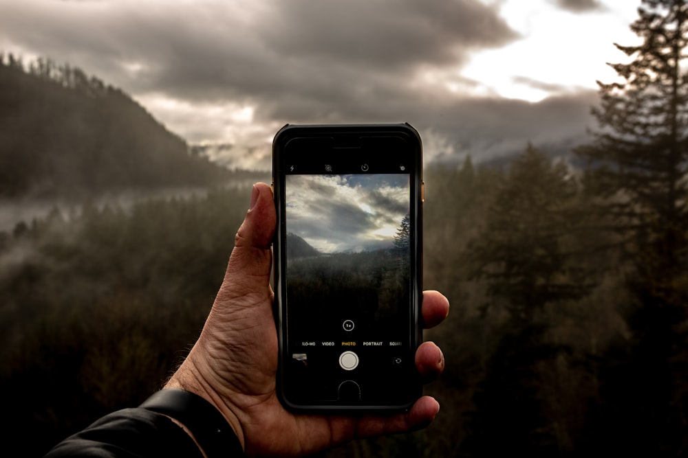 a person holding a cell phone in their hand