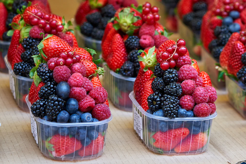 Assorted fresh berries in market punnets