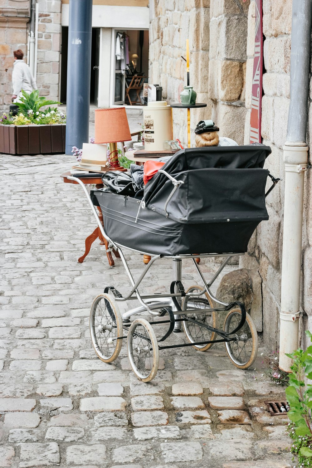 black stroller near wall