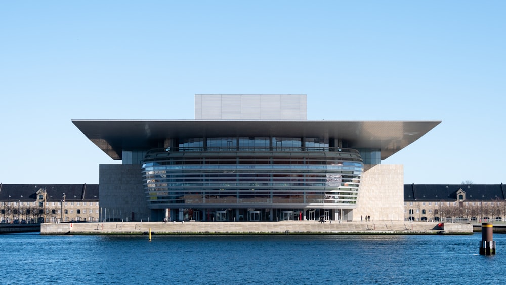 grey building at the harbor under clear blue sky