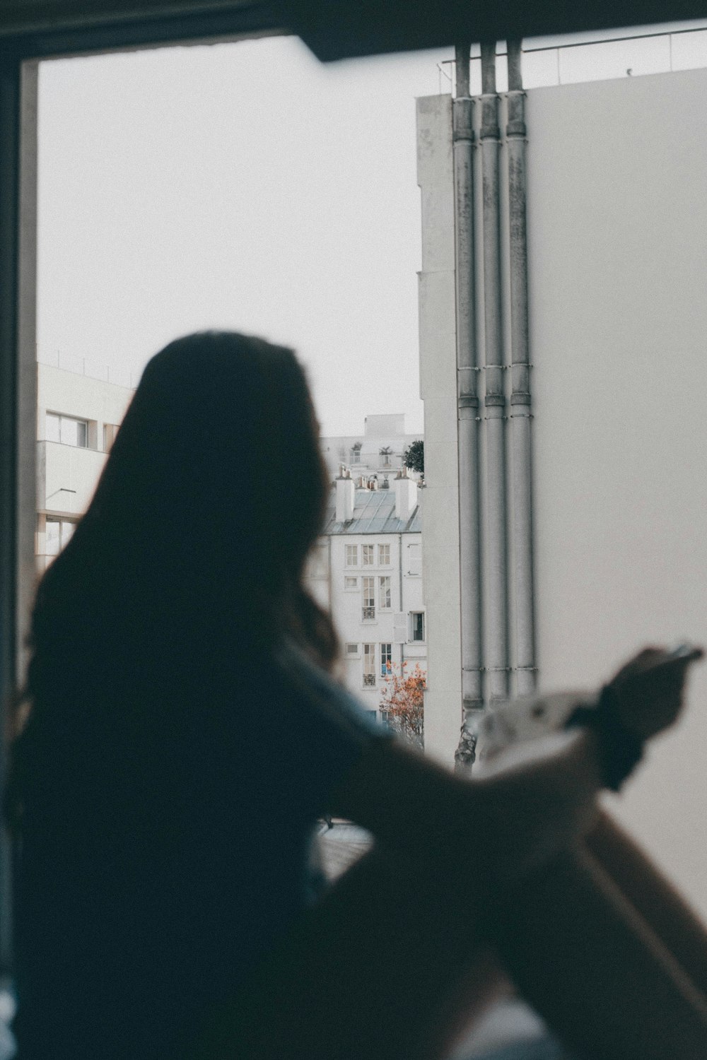 woman sitting near wall