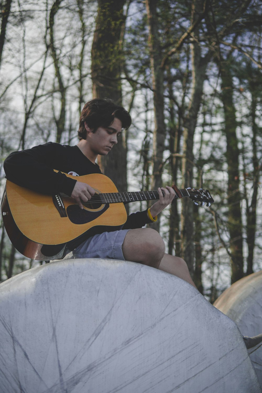 man playing guitar outdoors