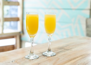 two orange juices on table