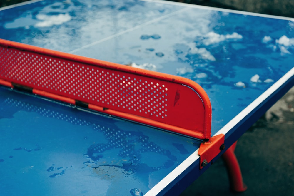 a ping pong table with a red racket on top of it