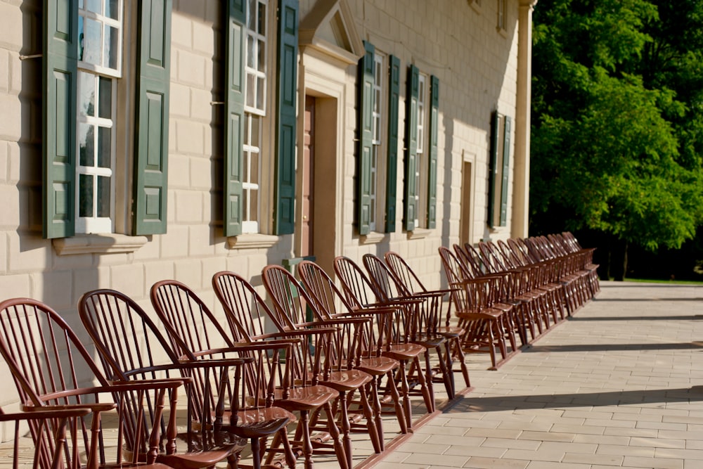 vacant wooden chairs beside house