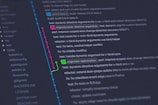 A computer screen displays a Git version control graph with branches and commits. Multiple colored lines and nodes indicate different branches merged and diverged. Text includes commit messages and details about changes made to the codebase. On the left, a list of directories and files relevant to a coding project is visible.