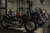 A row of shiny motorcycles in the studio, highlighting the red, black, and white color scheme.