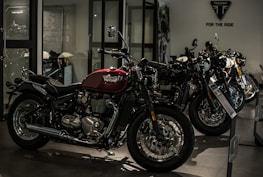 A row of shiny motorcycles in the studio, highlighting the red, black, and white color scheme.