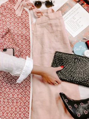 Flat lay of Maguis Colletion accessories including a handbag and matching shoes on a textured fabric.