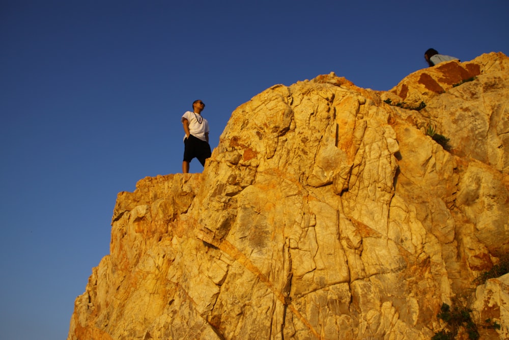man standing on cliff
