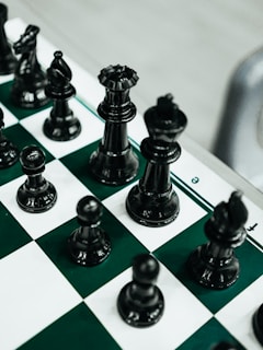 a close up of a chess board with pieces on it