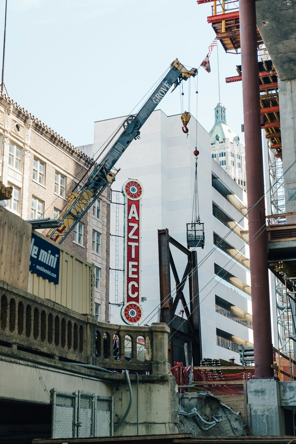 gray and yellow crane near buildings during daytime