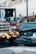 A fire truck and a black Nissan vehicle are involved in a collision at an urban intersection. The front of the car is severely damaged and white powder is visible on the ground, possibly from a fire extinguisher. The surroundings include city buildings and traffic lights.