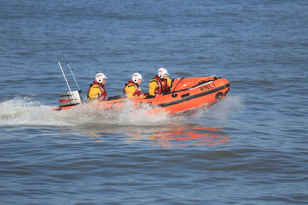 three people riding speedboat