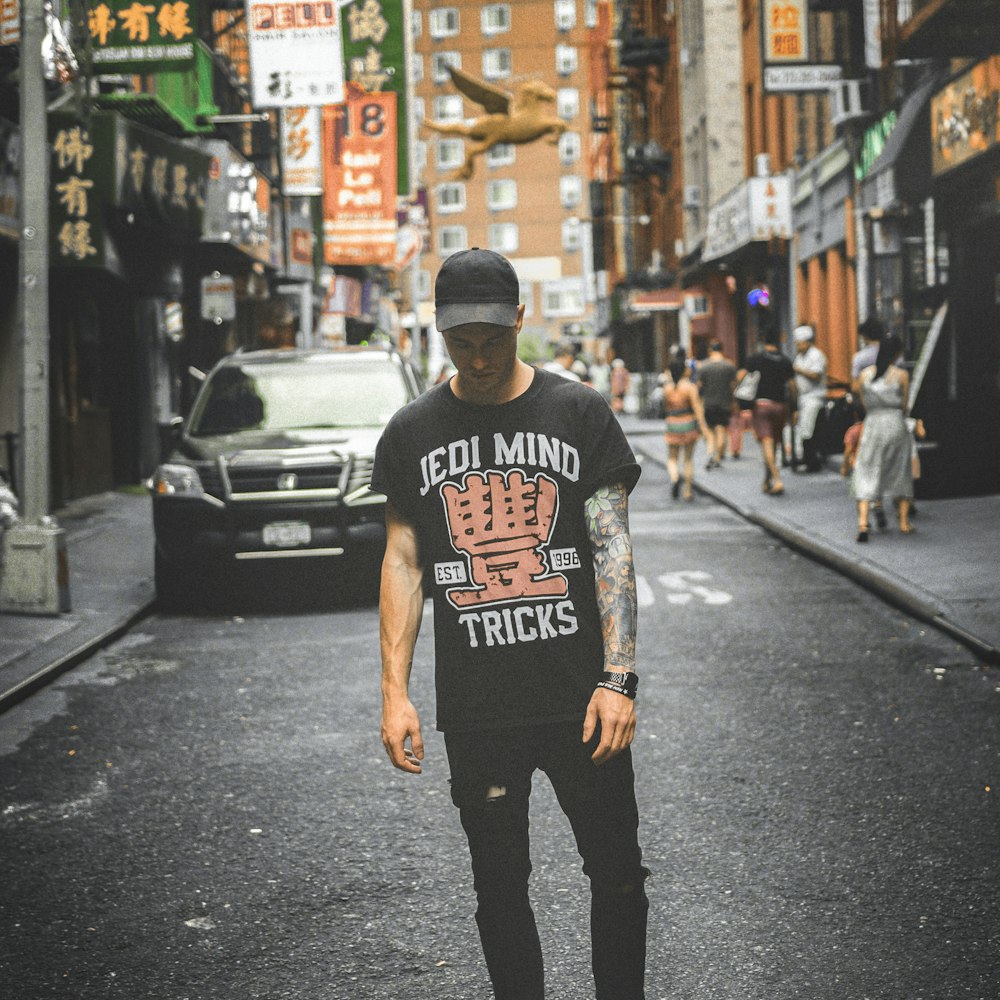 man standing on road near vehicle