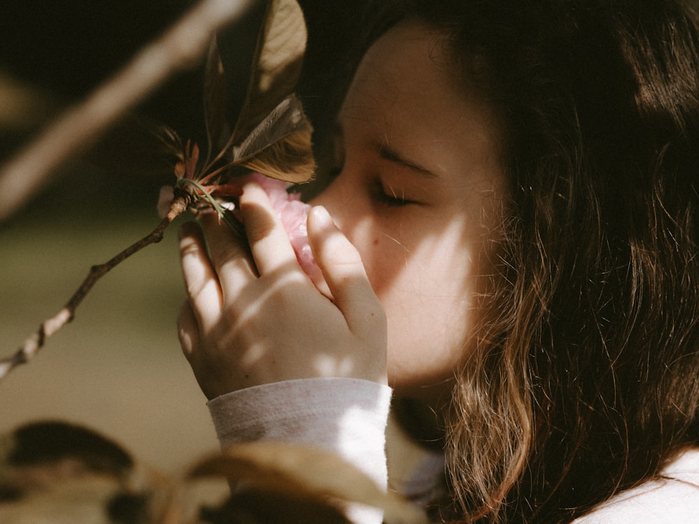 woman smeeling flower