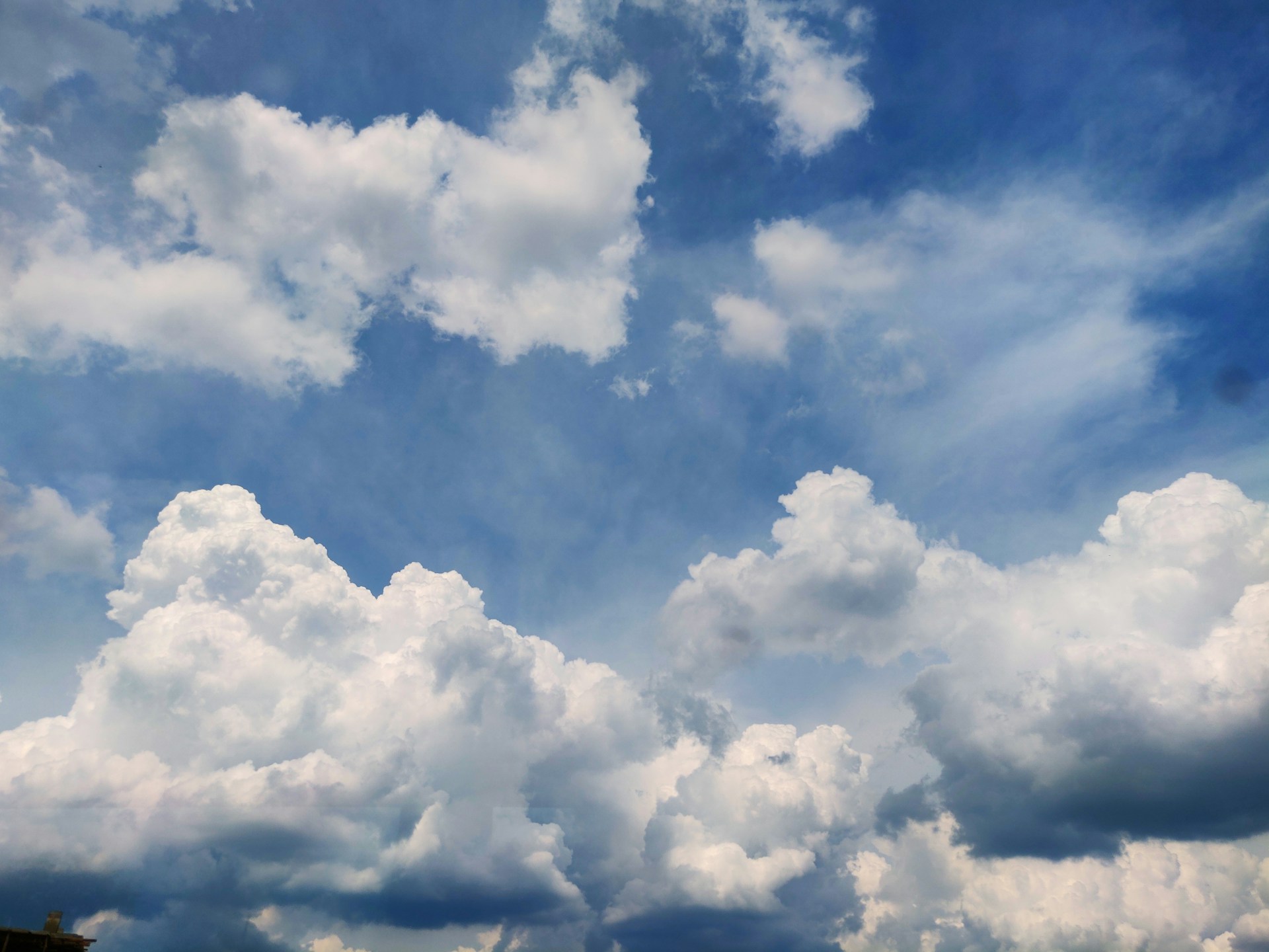 woman wearing yellow long-sleeved dress under white clouds and blue sky during daytime