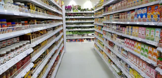 Modern supermarket aisle with sleek gondola shelving fully stocked and organized.