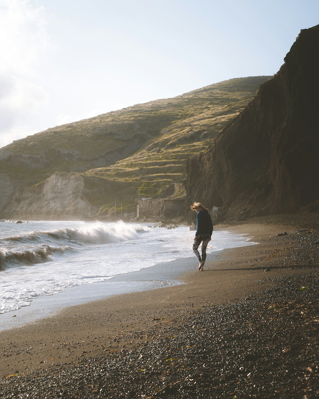 person walking on seashore outdoors