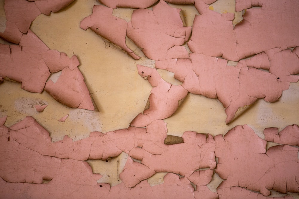 a close up of a wall with peeling paint