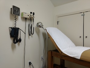 A consultation room featuring modern medical equipment.