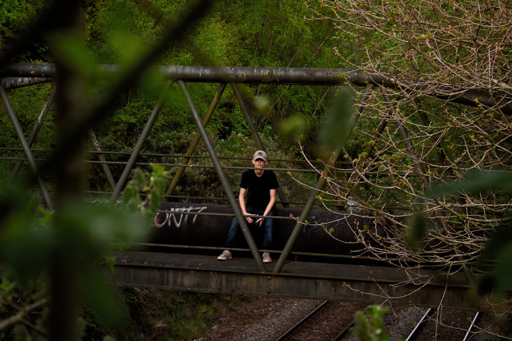 man sitting on the bridge