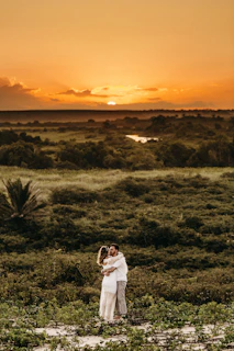 A romantic couple watching the sunset over the lush rainforests of North Madagascar.