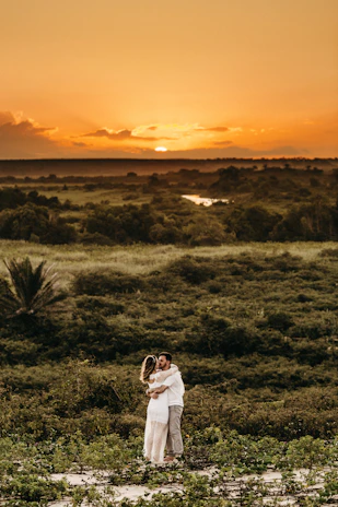 A romantic couple watching the sunset over the lush rainforests of North Madagascar.