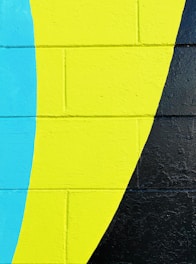 A vibrant mural on a city wall with bold colors and abstract shapes.