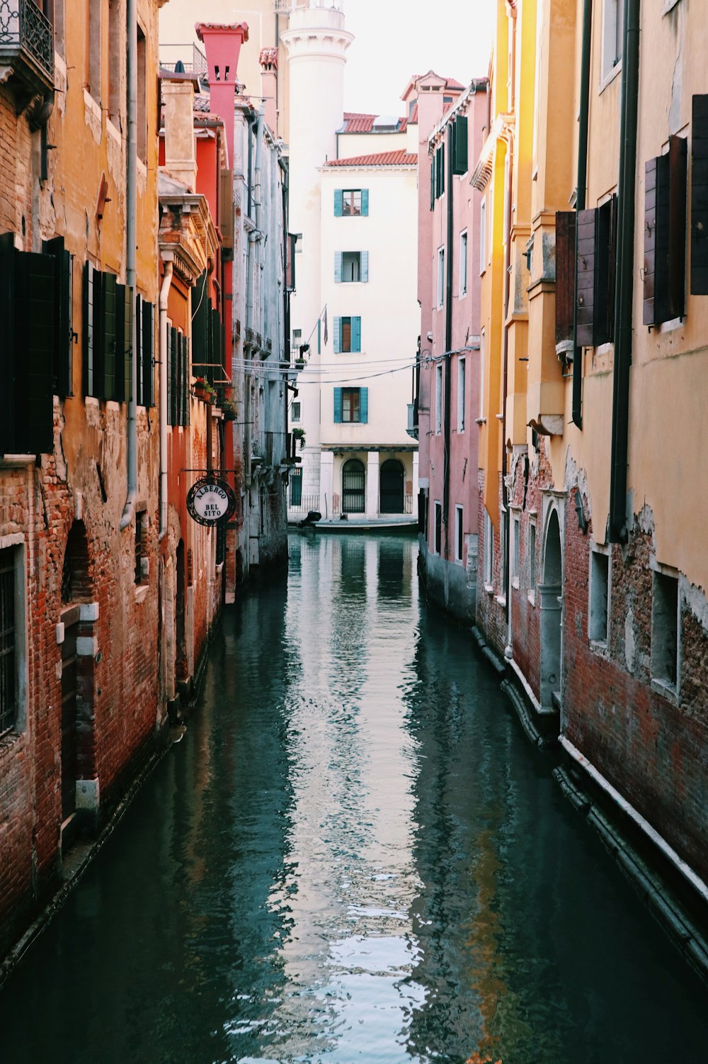 river in between buildings during daytime