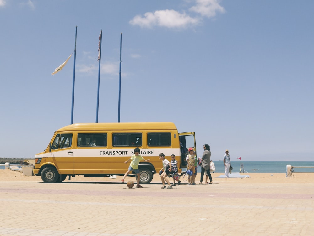 boys playing beside van