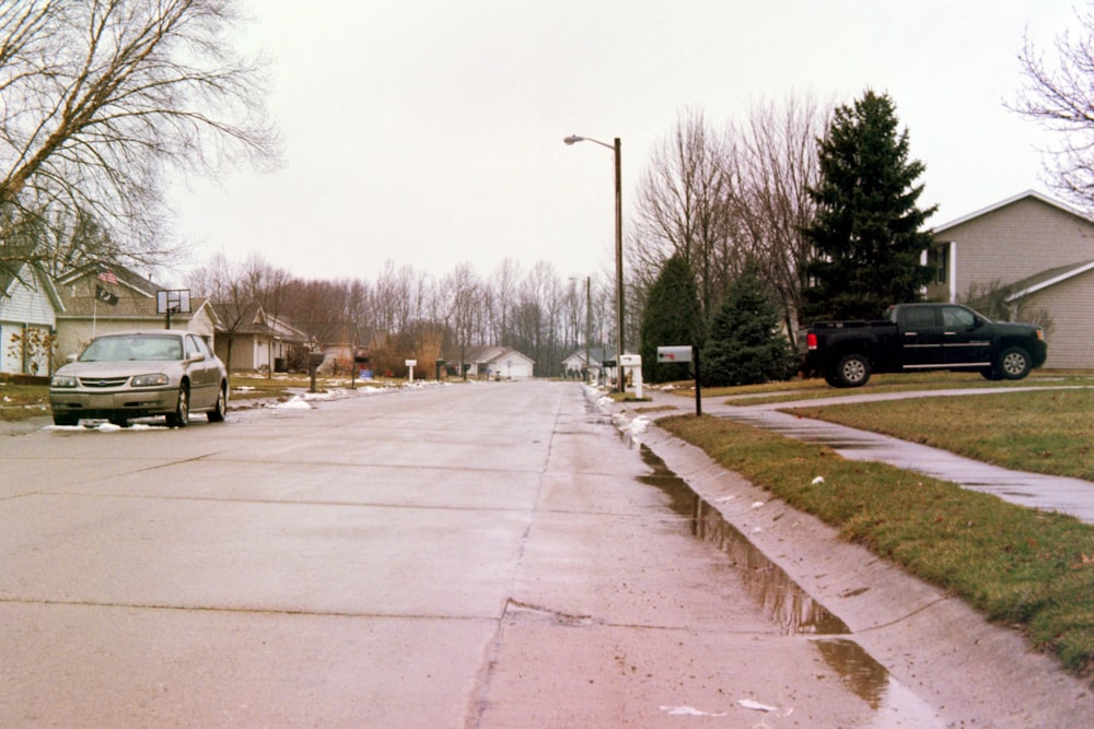 gray Chevrolet sedan parked near empty road