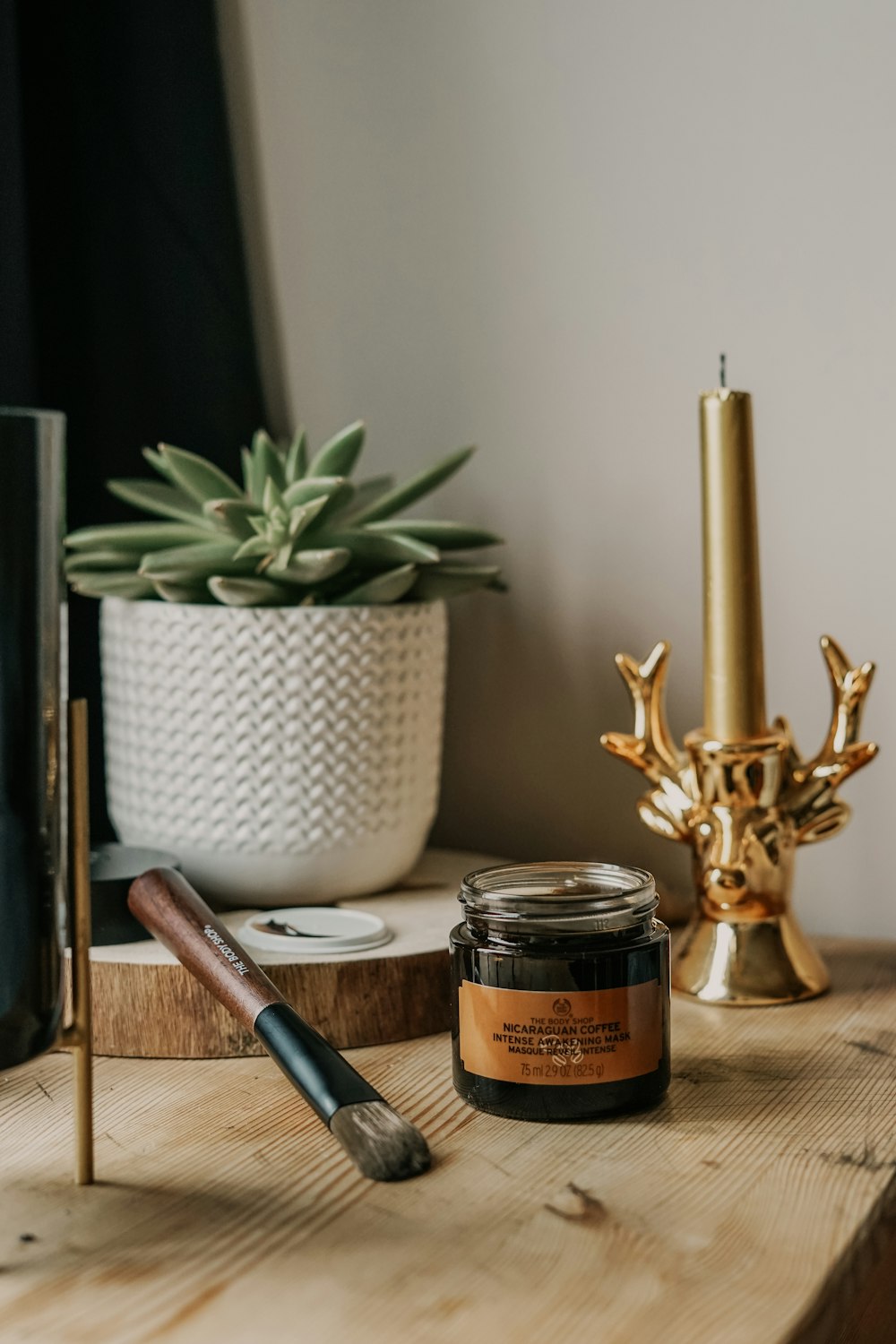 glass jar beside brown paint brush on table