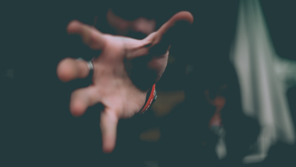 a blurry photo of a person's hand holding something