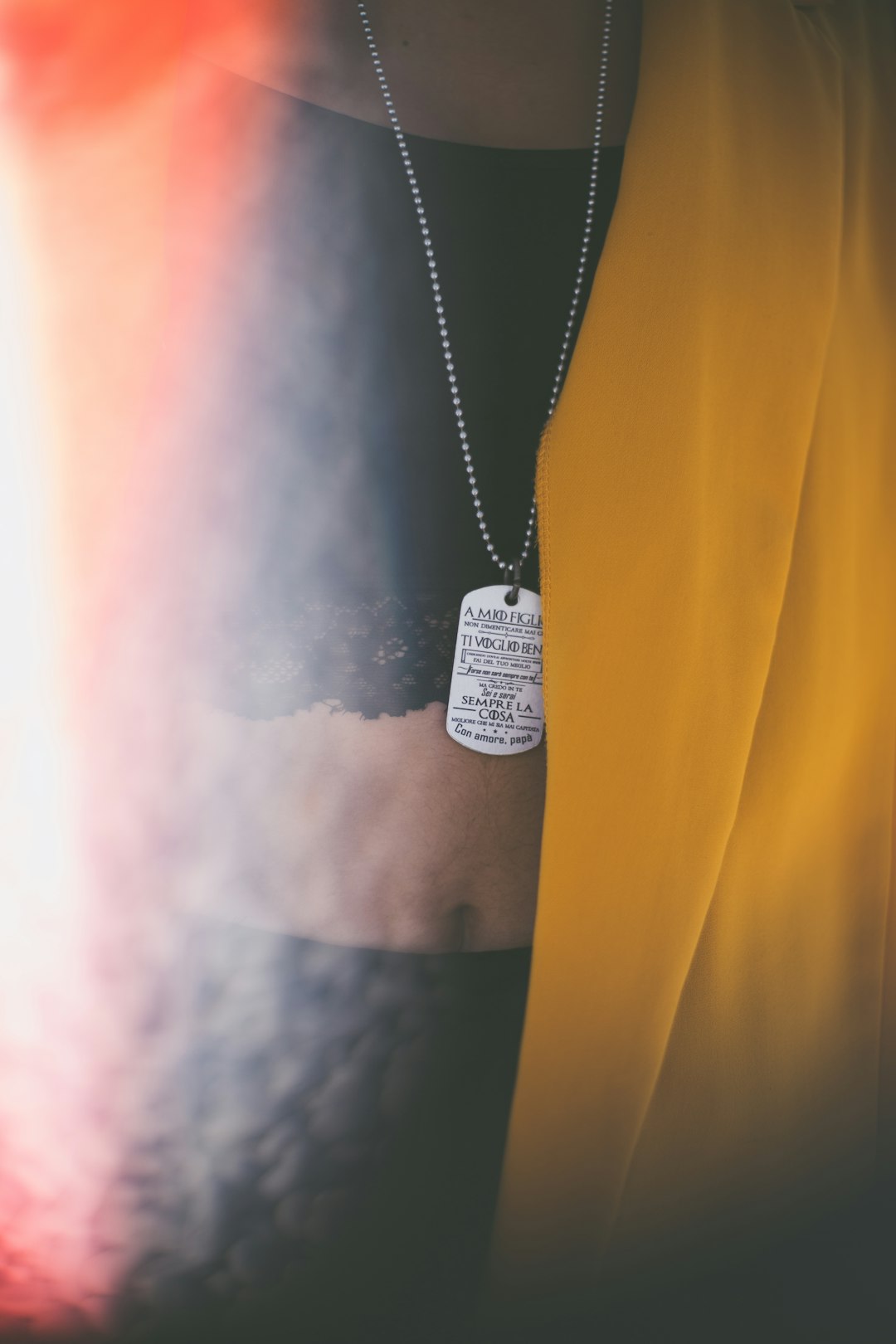 person wearing gray dog tag pendant