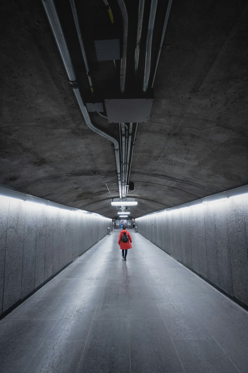person walking in tunnel