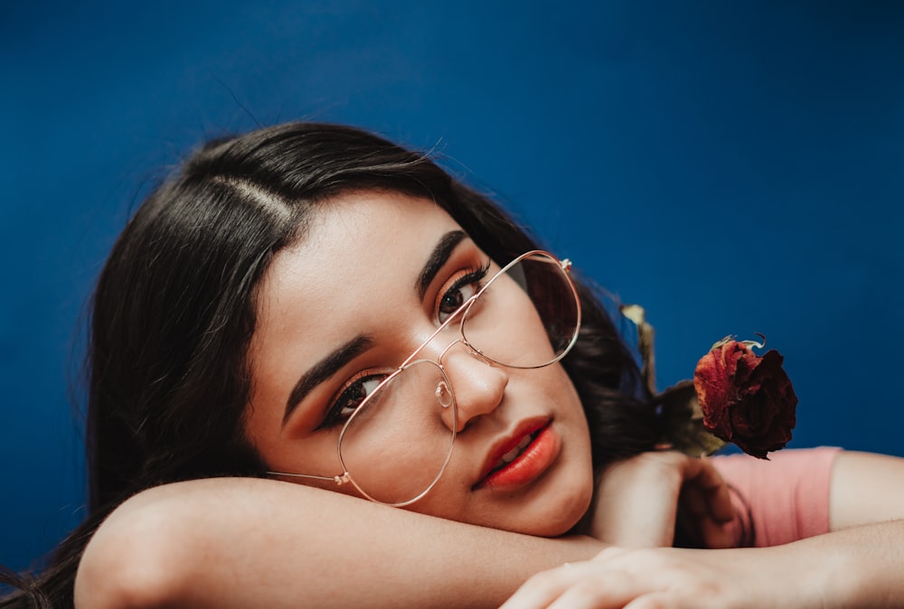 woman wearing gold-framed eyeglasses