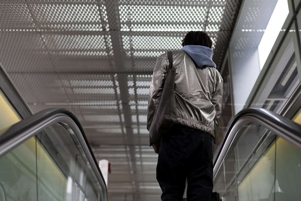 man standing on escalator