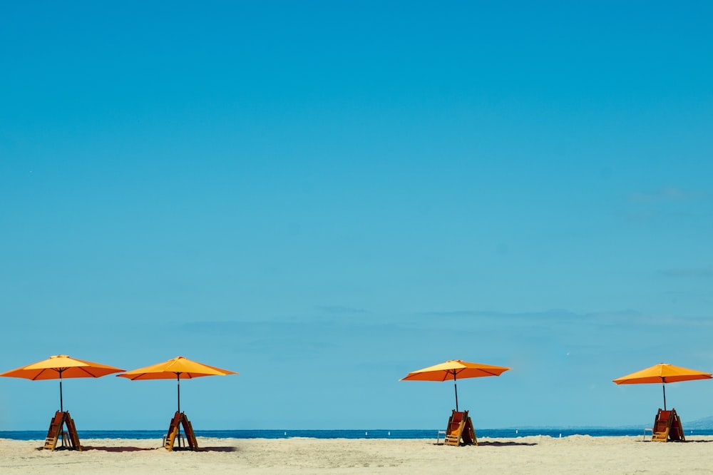 four yellow-and-orange parasols