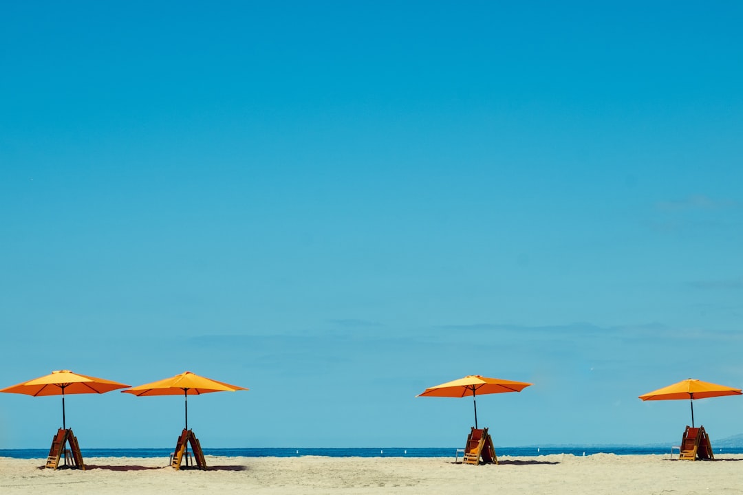 four yellow-and-orange parasols,