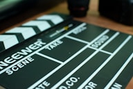 a close up of a movie clapper on a table by Donovan Silva (@donofunk)