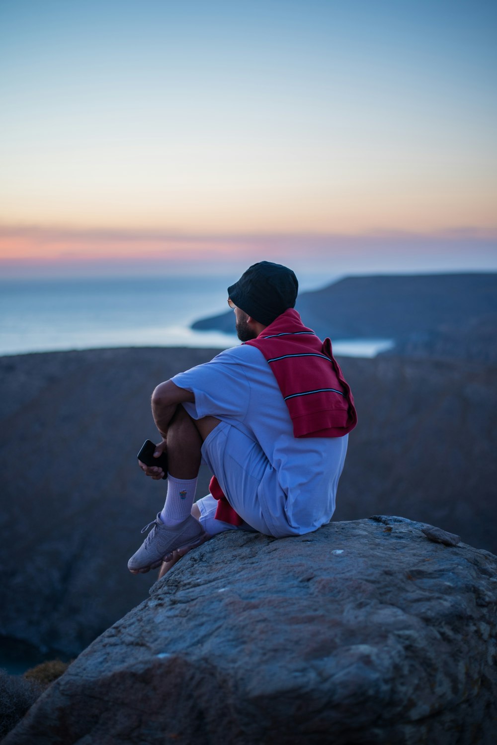 man sitting on rock