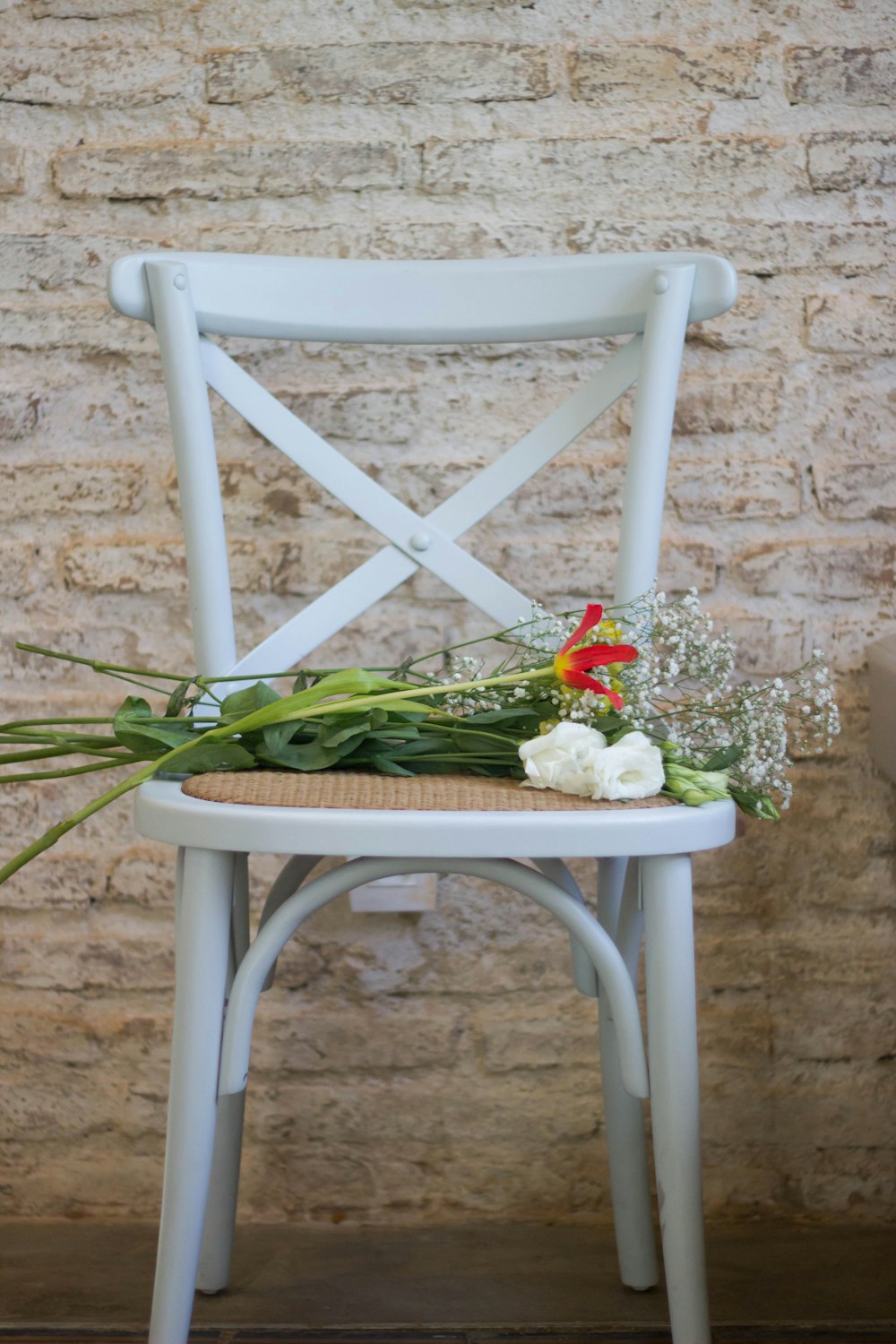 flowers on white wooden armless chair