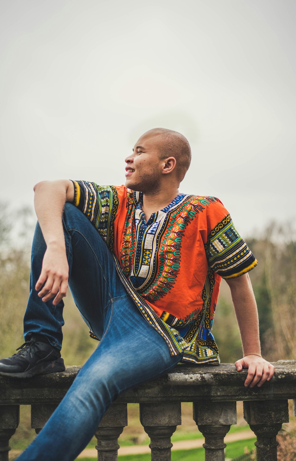 man in orange and green dashiki shirt