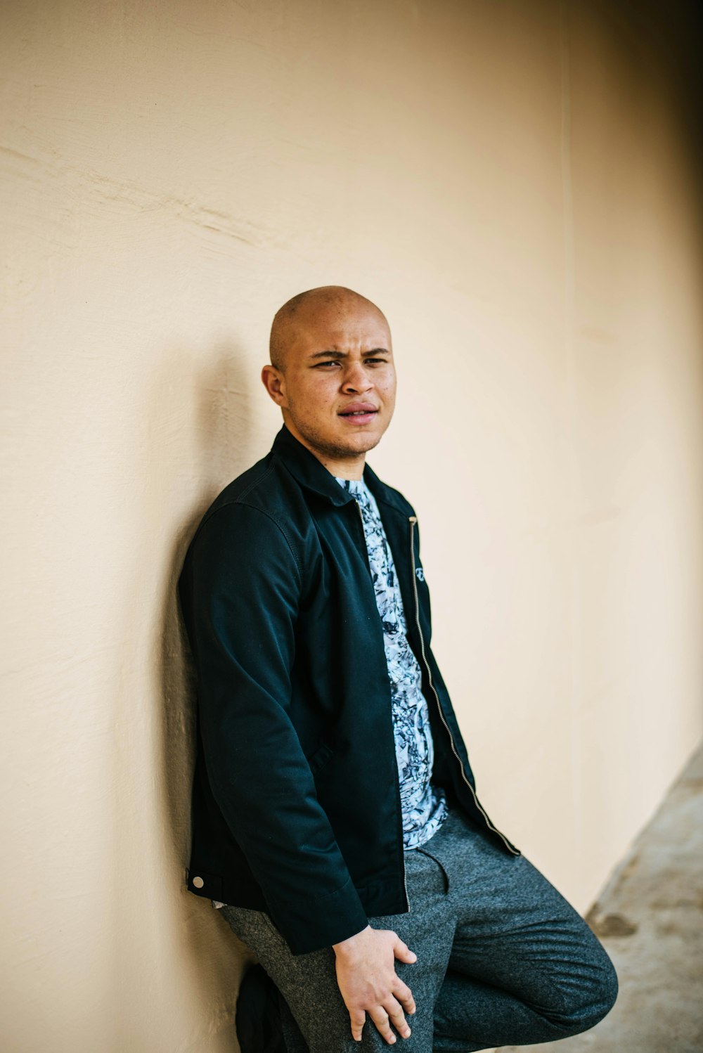 man leaning on wall