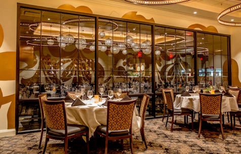Sophisticated dining area featuring a beautifully set table with fine china and ambient lighting.