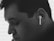 A close-up of a person listening to music through headphones, with a serene expression on their face.