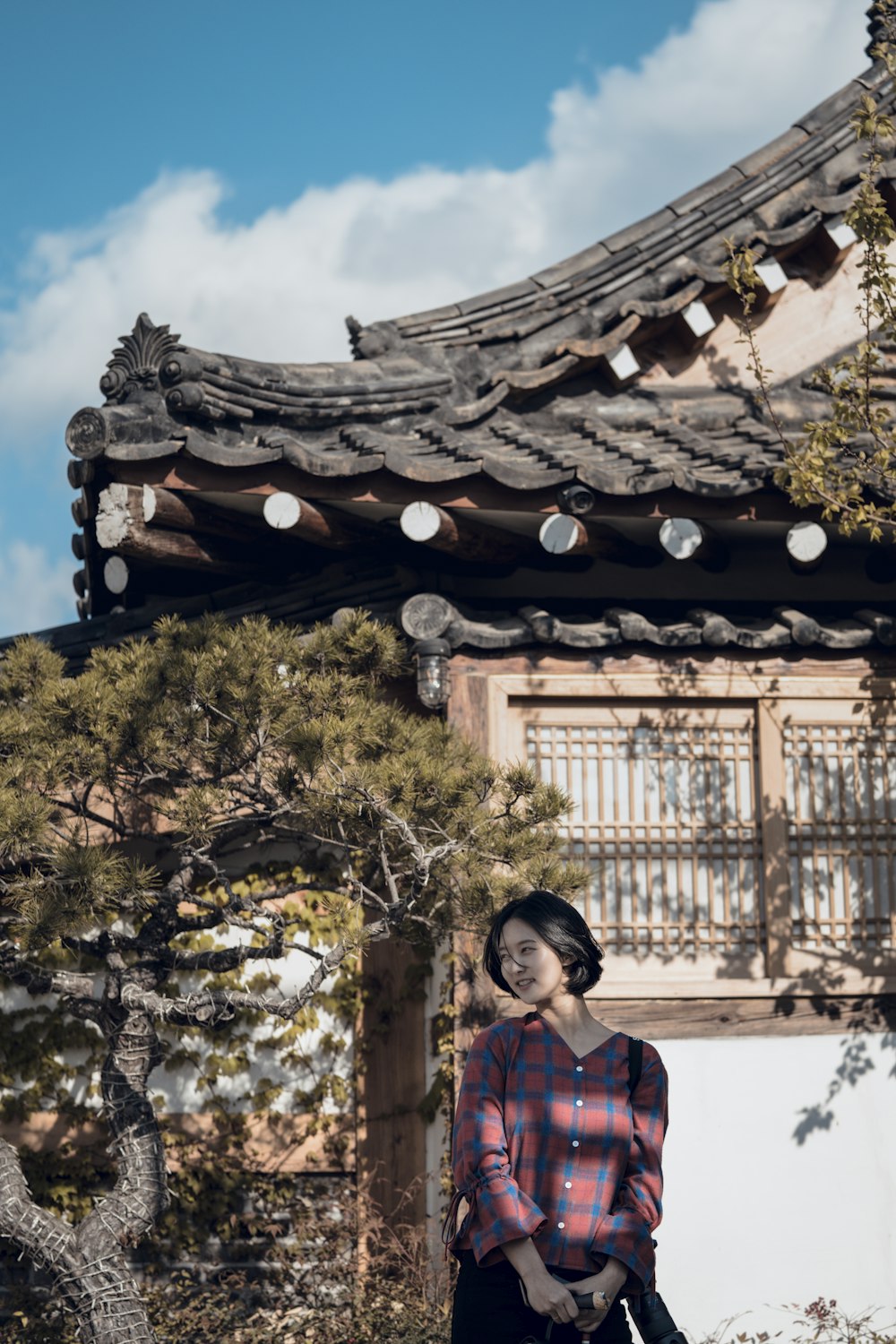 woman wearing sport shirt standing in front of house